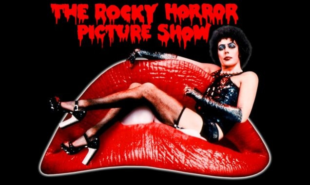 Tim Curry with makeup, leather, fishnets and heels sitting in a giant pair of red lips. Red text above reading: THE ROCKY HORROR PICTURE SHOW.